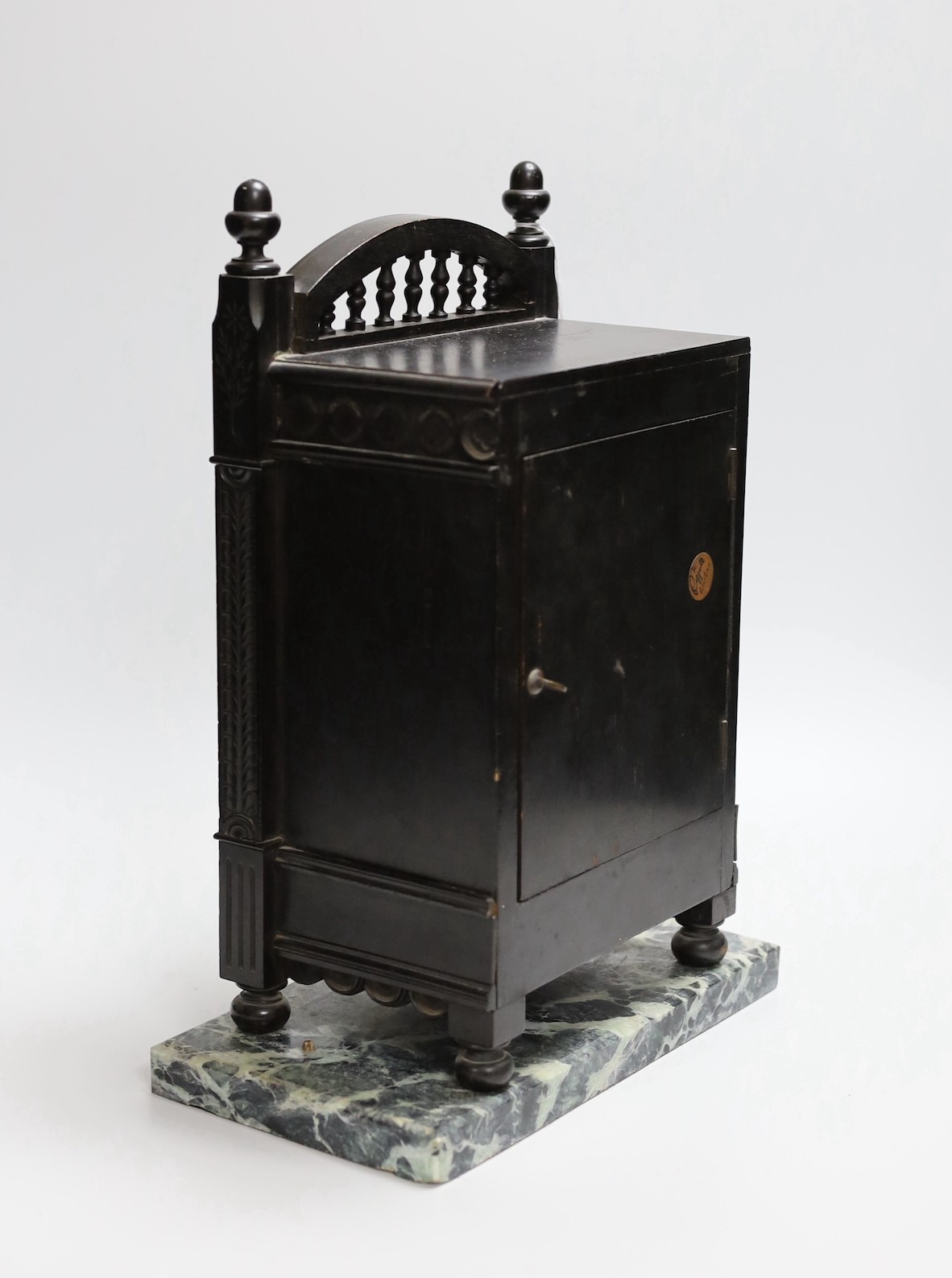 A Victorian Aesthetic Movement ebonised mantel clock in the manner of Walter Crane and Lewis Day. 32cm high